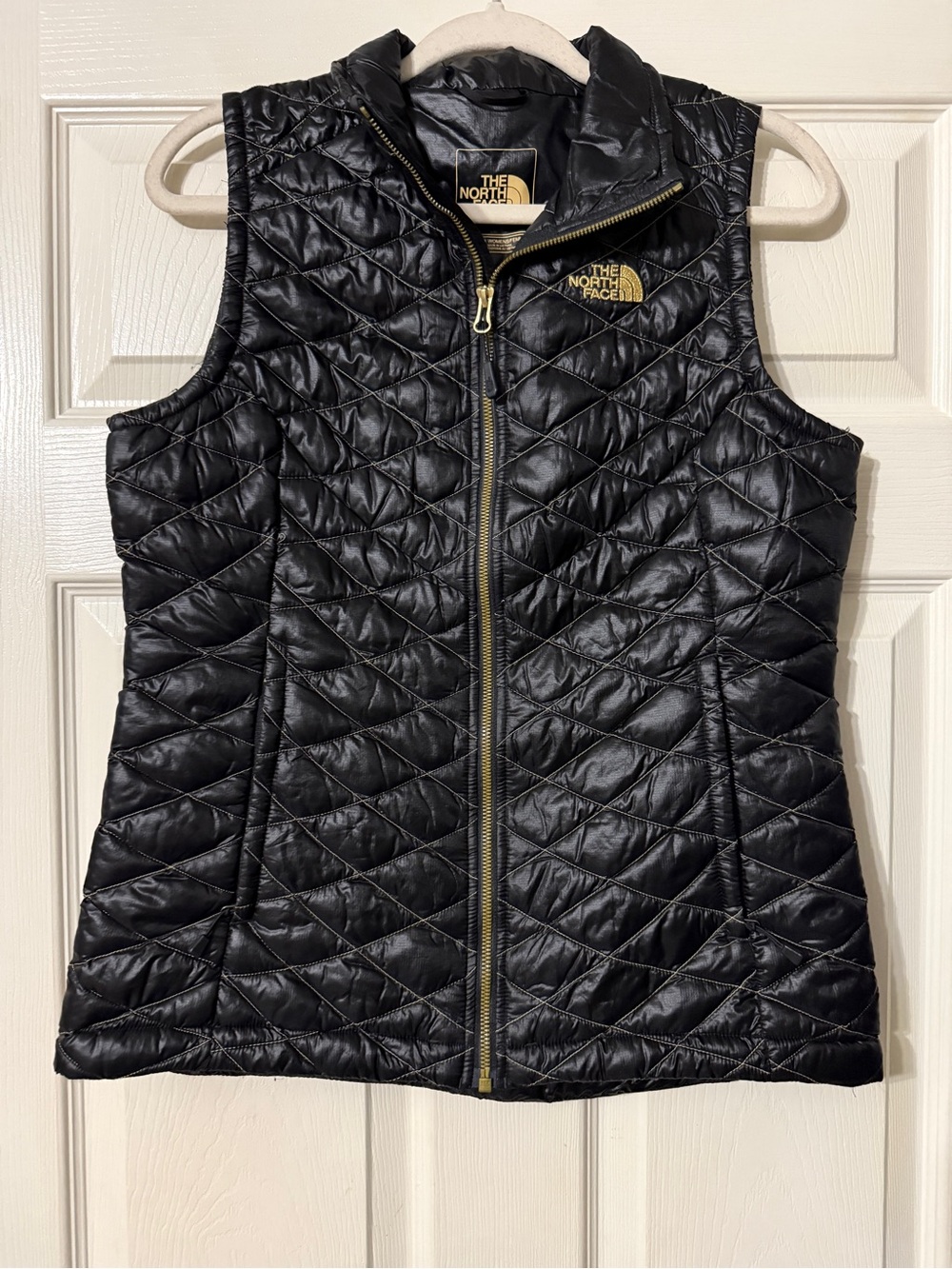 The North Face Black Quilted Women's Vest with Gold Logo & Zipper